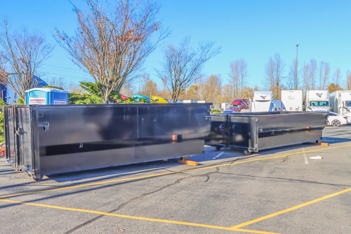 Professional dumpster rental service with roll-off container on residential driveway in La Verne